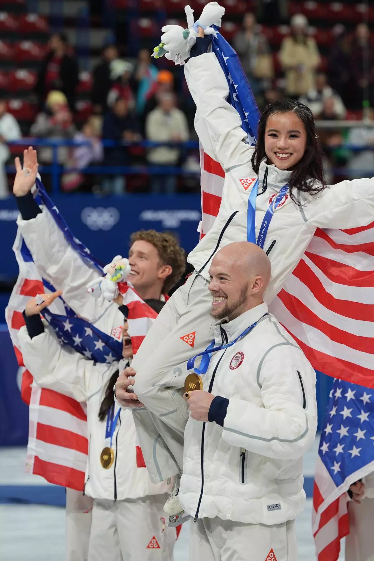 Team USA's Ellie Kam and Danny O'Shea pose with their gold medals after winning the figure skating team event at the 2026 Winter Olympics, in Milan, Italy, Sunday, Feb. 8, 2026. (AP Photo/Stephanie Scarbrough)