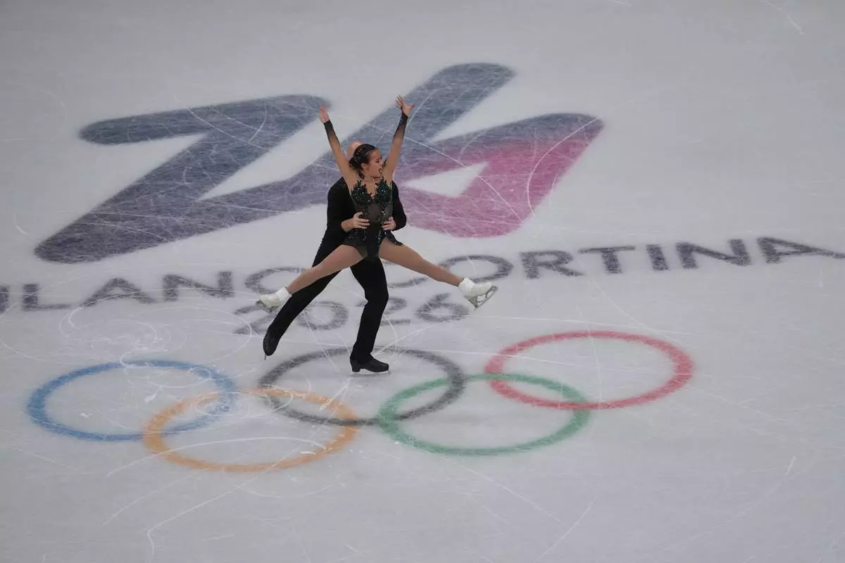 Ellie Kam and Danny O'Shea of the United States compete during the figure skating pairs team event at the 2026 Winter Olympics, in Milan, Italy, Sunday, Feb. 8, 2026. (AP Photo/Natacha Pisarenko)