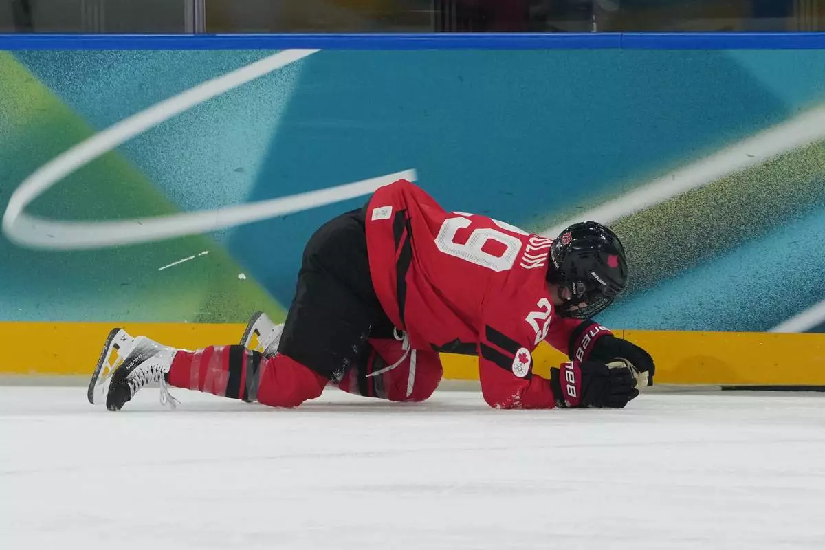 Canada's Marie-Philip Poulin (29) is down on the ice in the first period against Czechia during a preliminary round match of women's ice hockey at the 2026 Winter Olympics, in Milan, Italy, Monday, Feb. 9, 2026. (AP Photo/Carolyn Kaster)