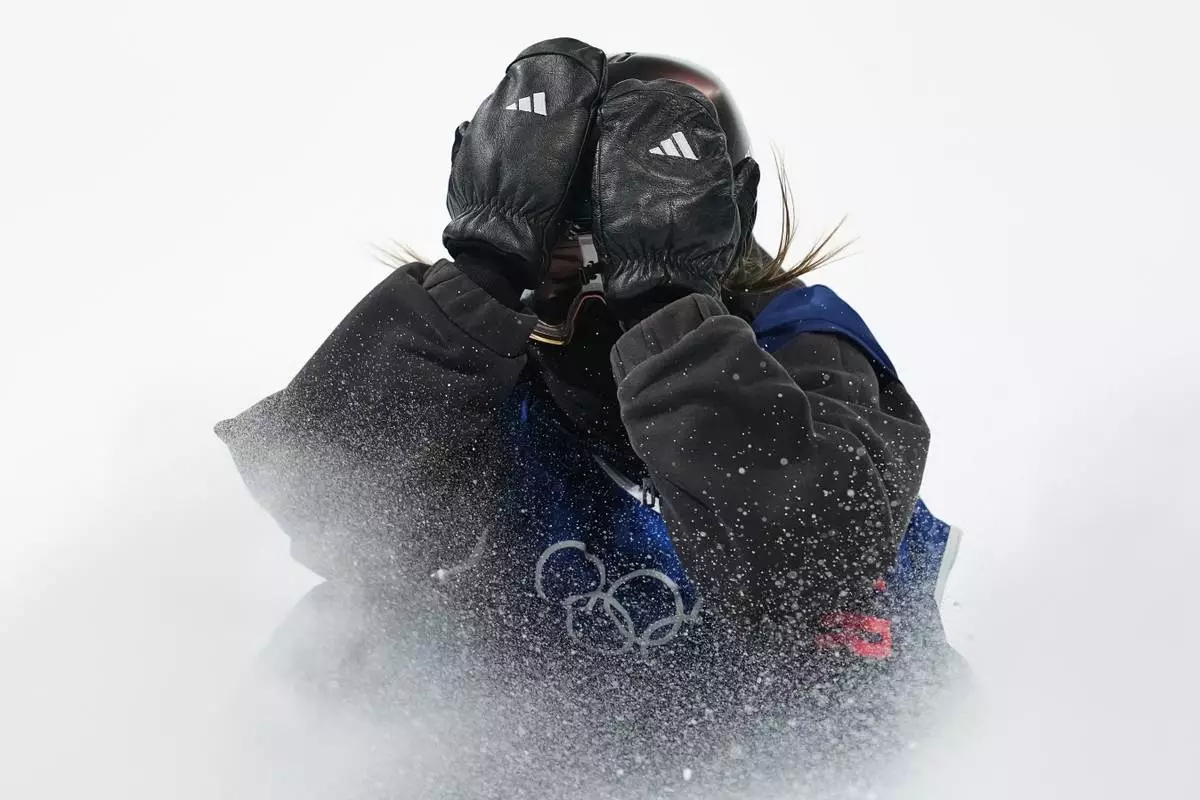 Britain's Mia Brookes reacts during the women's snowboarding big air finals at the 2026 Winter Olympics, in Livigno, Italy, Monday, Feb. 9, 2026. (AP Photo/Lindsey Wasson)