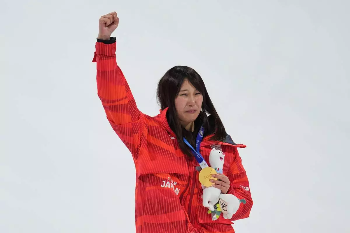 Gold medalist Japan's Kokomo Murase celebrates winning the women's snowboarding big air finals at the 2026 Winter Olympics, in Livigno, Italy, Monday, Feb. 9, 2026. (AP Photo/Abbie Parr)