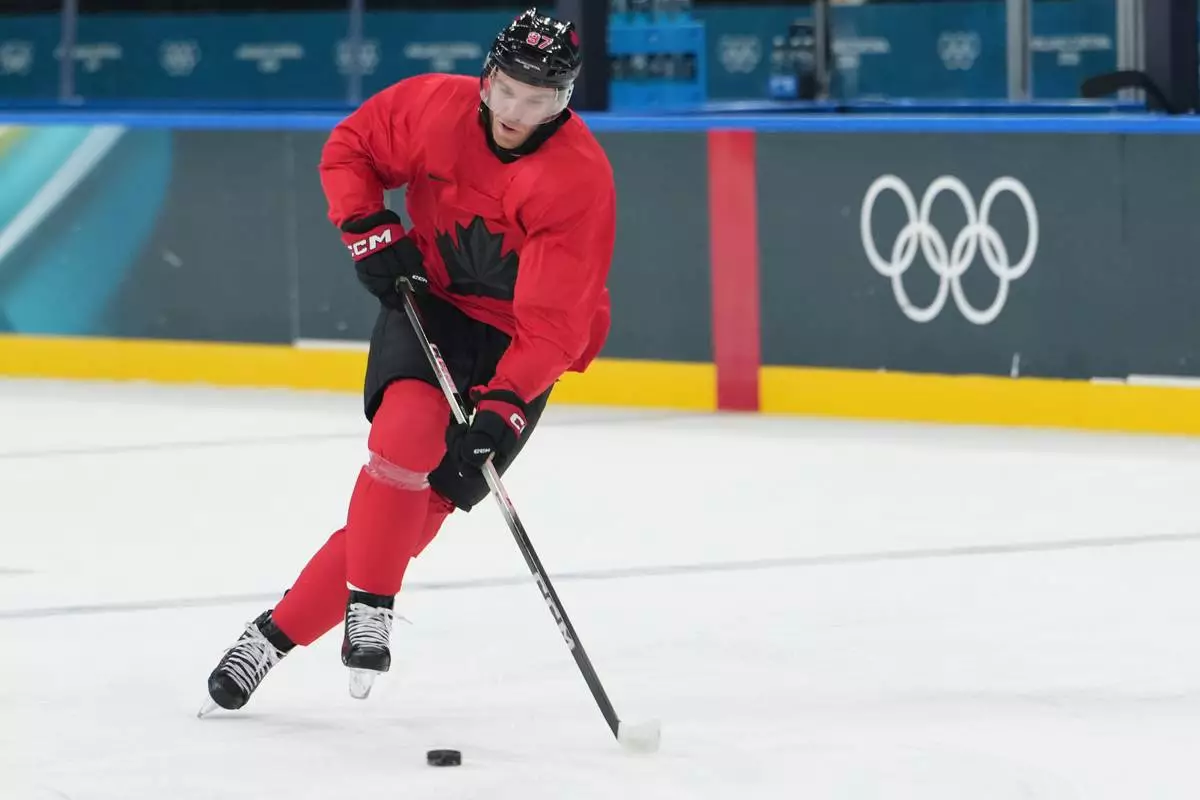 Canada's Connor McDavid skates with the puck during men's ice hockey practice at the 2026 Winter Olympics, in Milan, Italy, Sunday, Feb. 8, 2026. (AP Photo/Carolyn Kaster)