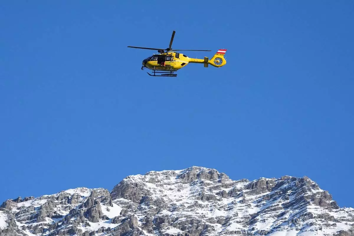A rescue helicopter flies past ahead of an alpine ski men's downhill portion of a team combined race, at the 2026 Winter Olympics, in Bormio, Italy, Monday, Feb. 9, 2026. (AP Photo/Rebecca Blackwell)