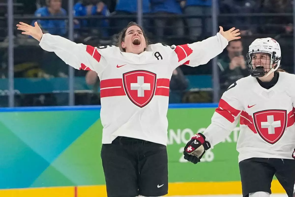 Switzerland's Alina Muller (25) celebrates after a women's ice hockey bronze medal game between Switzerland and Sweden at the 2026 Winter Olympics, in Milan, Italy, Thursday, Feb. 19, 2026. (AP Photo/Hassan Ammar)