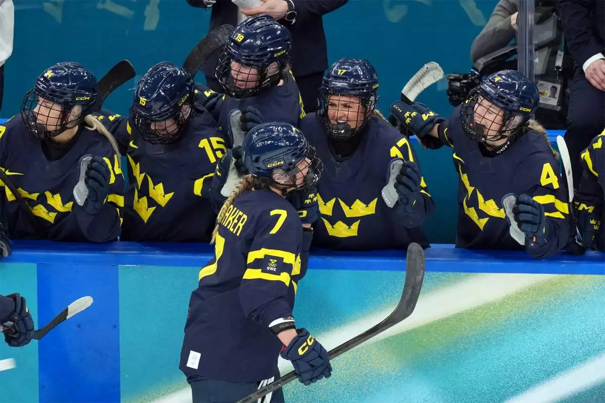 Sweden's Mira Jungaker (7) is congratulated after scoring a goal against Switzerland during the second period of the women's ice hockey bronze medal game at the 2026 Winter Olympics, in Milan, Italy, Thursday, Feb. 19, 2026. (AP Photo/Carolyn Kaster)