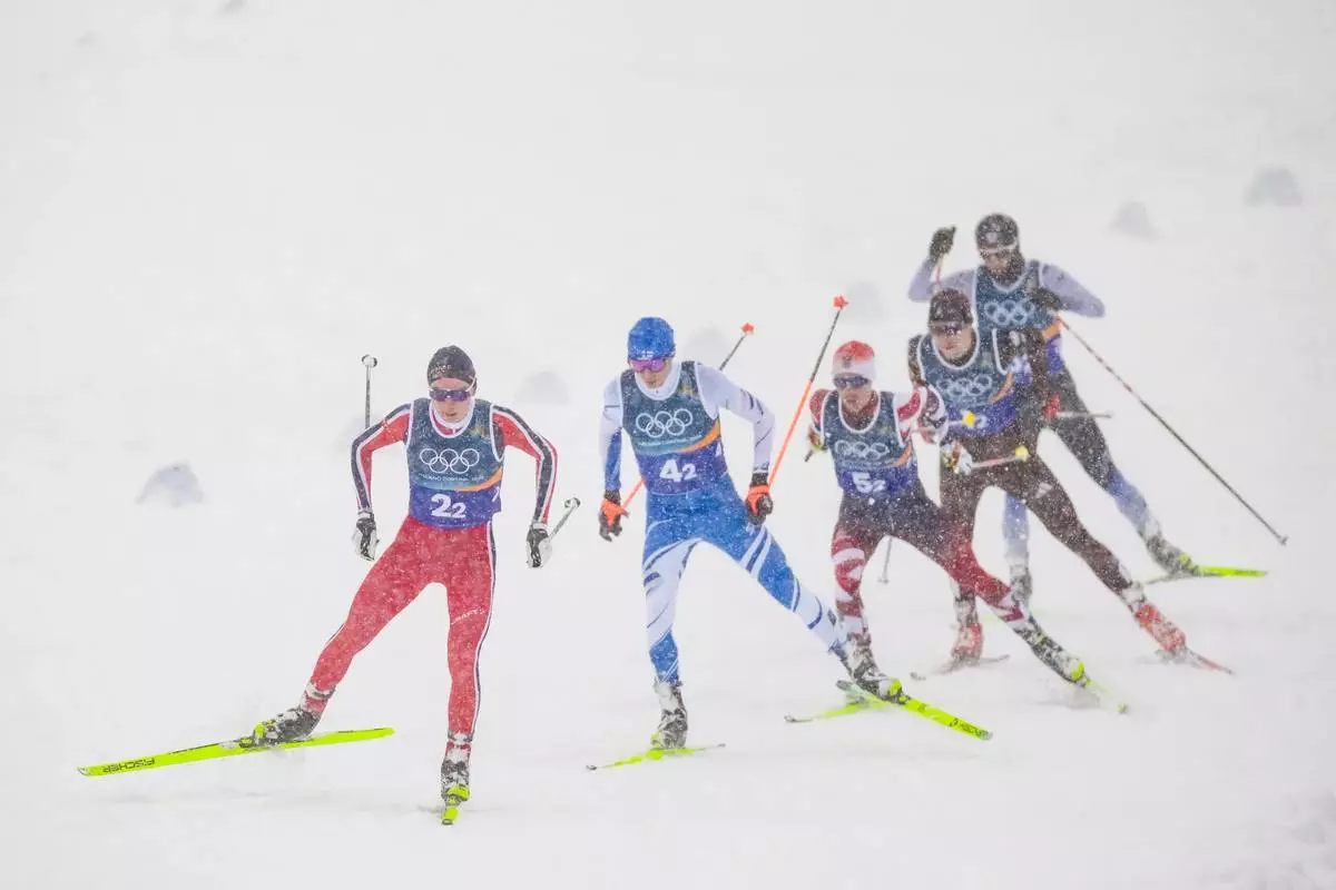 Jens Luraas Oftebro, of Norway, from left, Eero Hirvonen, of Finland, Johannes Lamparter, of Austria, Vinzenz Geiger, of Germany, and Ryota Yamamoto, of Japan, compete in the nordic combined team sprint at the 2026 Winter Olympics, in Tesero, Italy, Thursday, Feb. 19, 2026. (AP Photo/Evgeniy Maloletka)