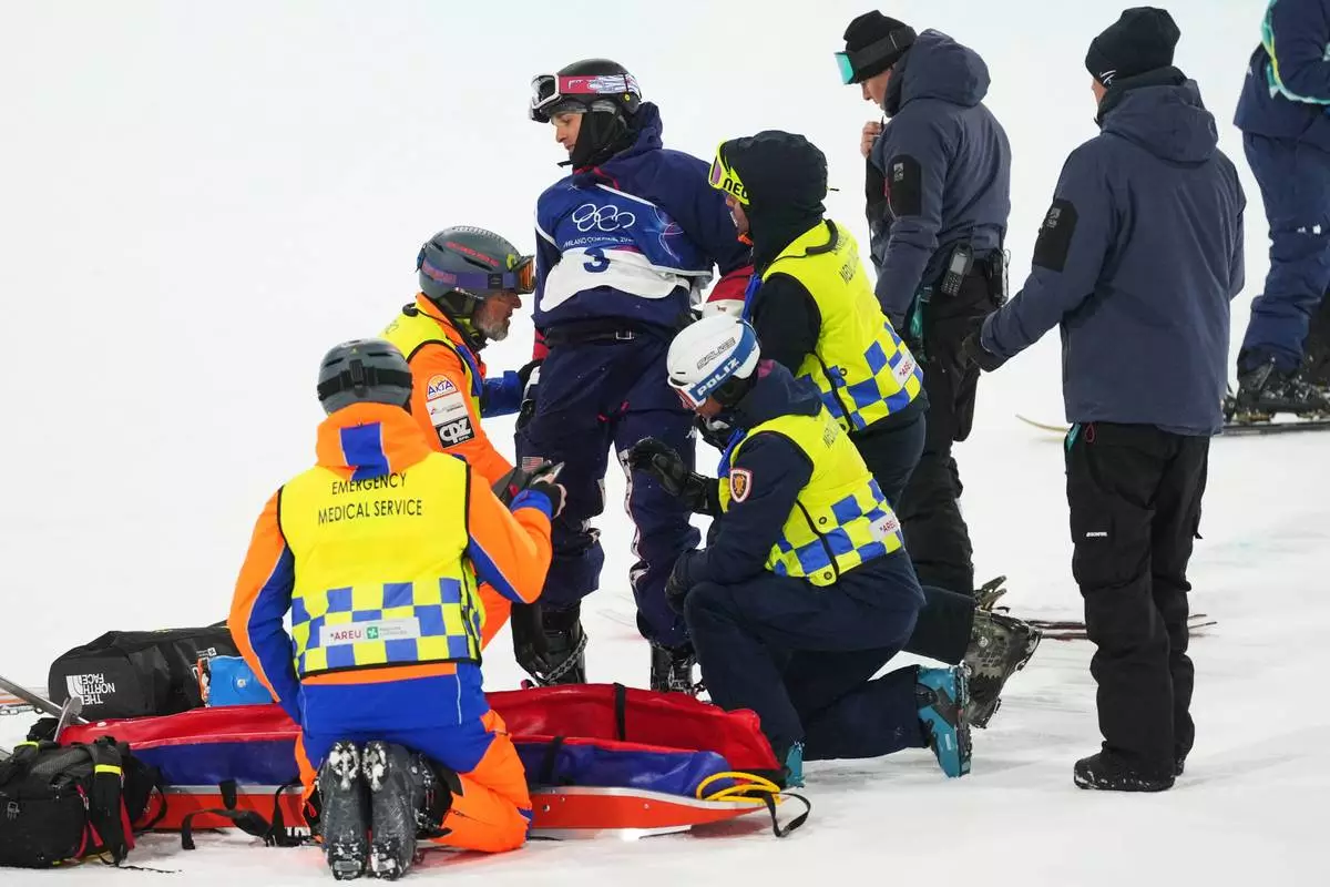 Medics respond after United States' Nick Goepper crashed during the men's freestyle skiing halfpipe finals at the 2026 Winter Olympics, in Livigno, Italy, Friday, Feb. 20, 2026. (AP Photo/Lindsey Wasson)