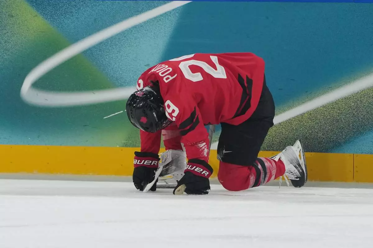Canada's Marie-Philip Poulin (29) is down on the ice in the first period against Czechia during a preliminary round match of women's ice hockey at the 2026 Winter Olympics, in Milan, Italy, Monday, Feb. 9, 2026. (AP Photo/Carolyn Kaster)