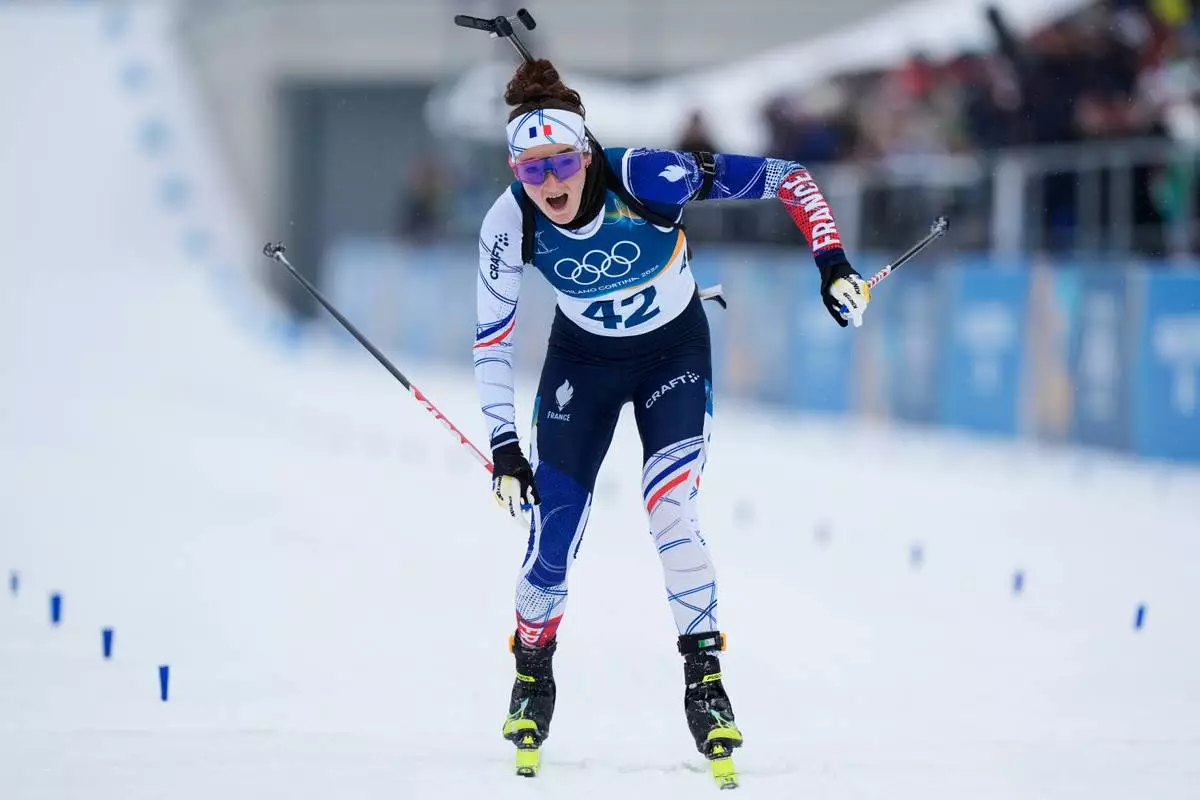 Lou Jeanmonnot, of France, skis to the finsh area of the women's 7.5-kilometer sprint biathlon race at the 2026 Winter Olympics in Anterselva, Italy, Saturday, Feb. 14, 2026. (AP Photo/Andrew Medichini)
