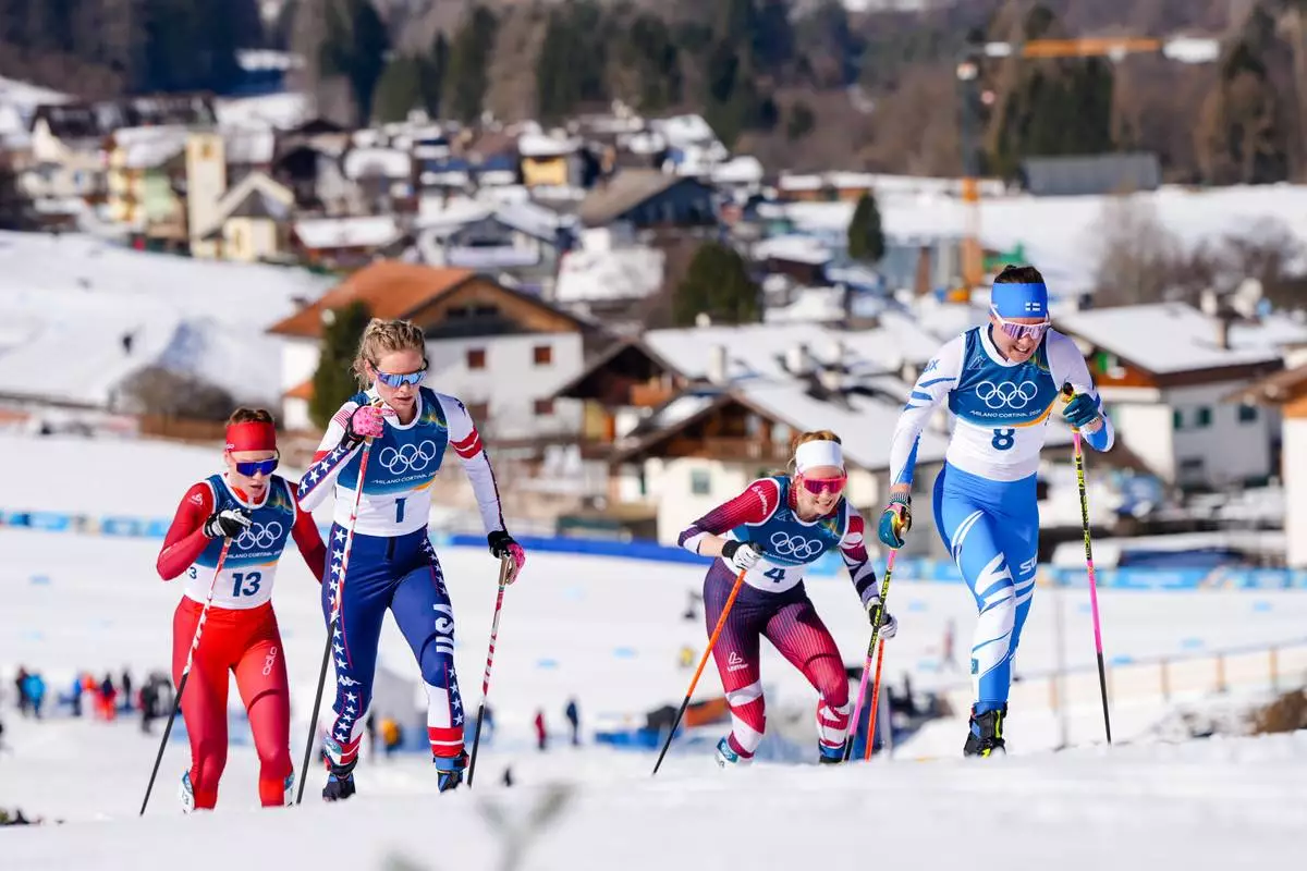 Kerttu Niskanen, of Finland, from right, Teresa Stadlober, of Austria, Jessie Diggins, of the United States, and Nadja Kaelin, of Switzerland, compete in the cross country skiing women's 50km mass start classic at the 2026 Winter Olympics, in Tesero, Italy, Sunday, Feb. 22, 2026. (AP Photo/Kirsty Wigglesworth)