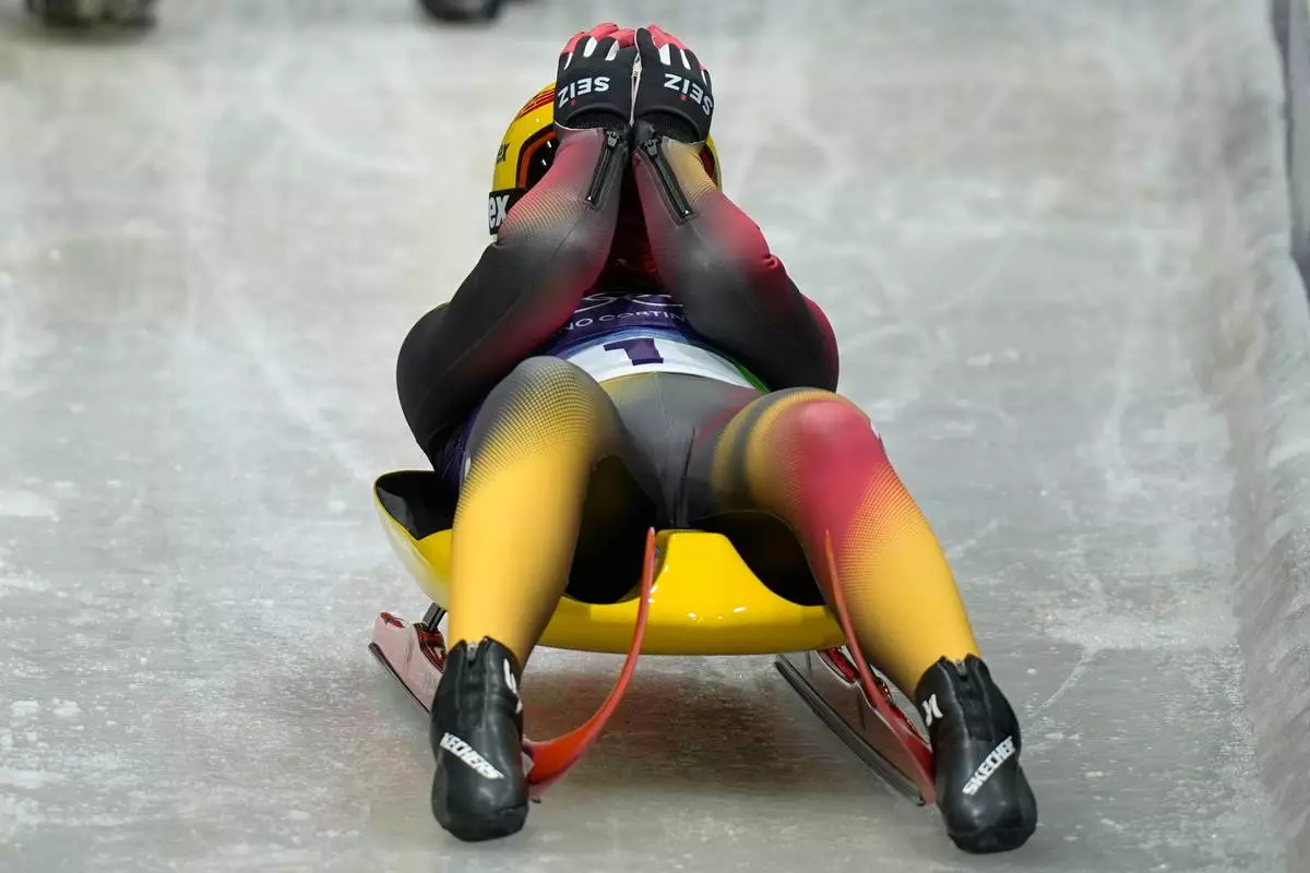 Germany's Julia Taubitz celebrates winning the gold medal during a women's single luge competition at the 2026 Winter Olympics, in Cortina d'Ampezzo, Italy, Tuesday, Feb. 10, 2026. (AP Photo/Aijaz Rahi)