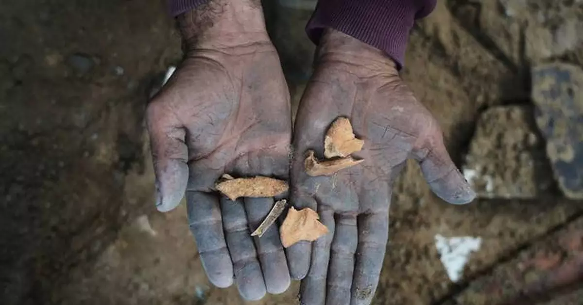 A father in Gaza searches for his family's bones in the rubble of their home