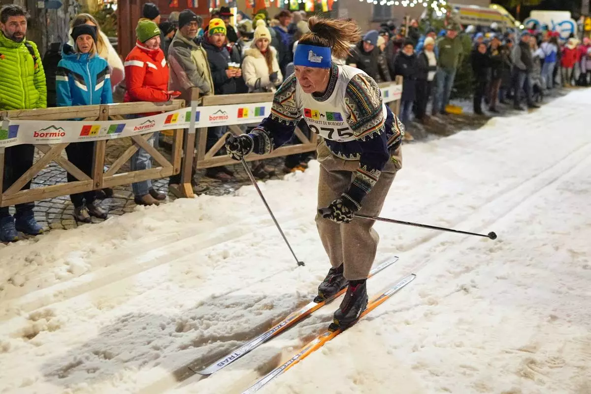 Bormio residents participate in an annual cross-country ski race through the streets of the old town, this year coinciding with the 2026 Winter Olympics, in Bormio, Italy, Friday, Feb. 13, 2026. (AP Photo/Rebecca Blackwell)