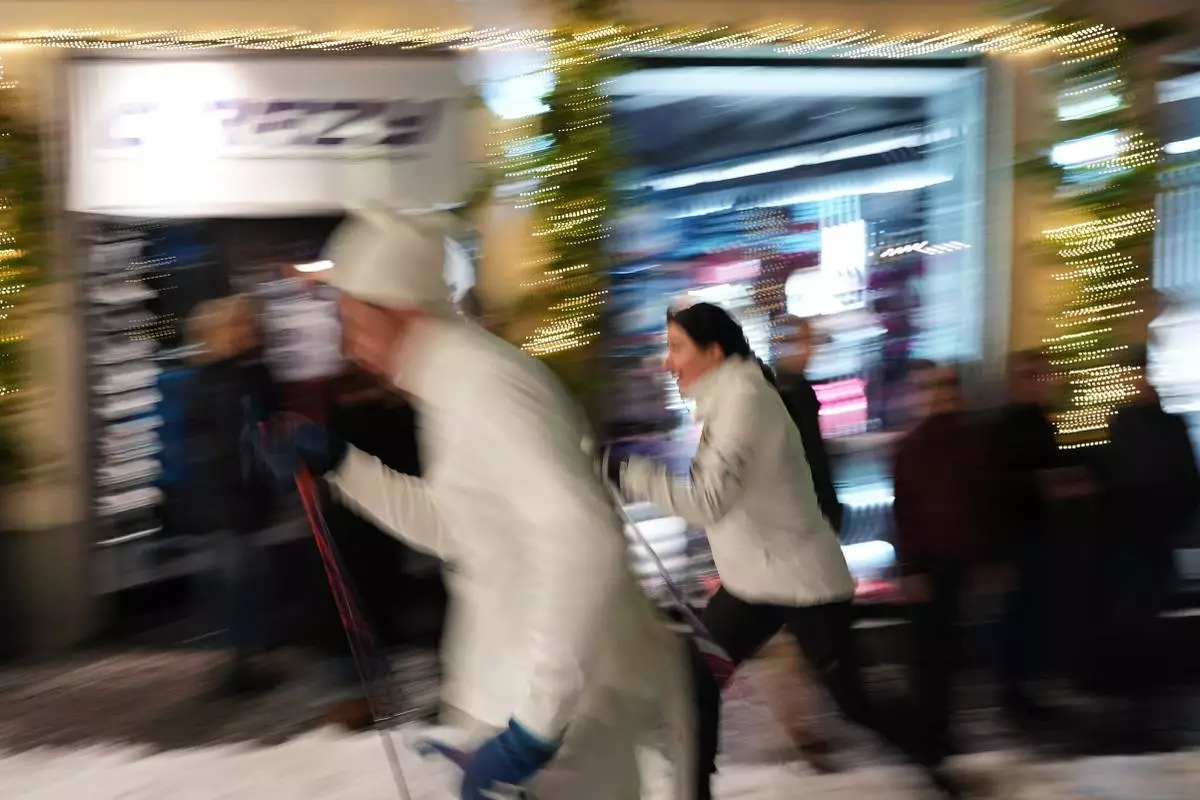 Bormio residents compete in an annual cross-country ski race through the streets of the old town, this year coinciding with the 2026 Winter Olympics, in Bormio, Italy, Friday, Feb. 13, 2026. (AP Photo/Rebecca Blackwell)