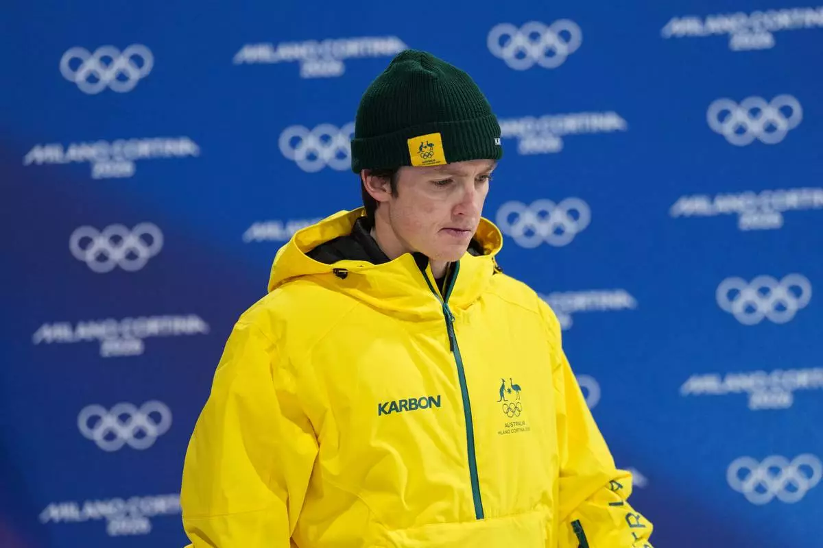 Silver medalist Australia's Scotty James reacts as he arrives for the medal ceremony after the men's snowboarding halfpipe finals at the 2026 Winter Olympics, in Livigno, Italy, Friday, Feb. 13, 2026. (AP Photo/Abbie Parr)