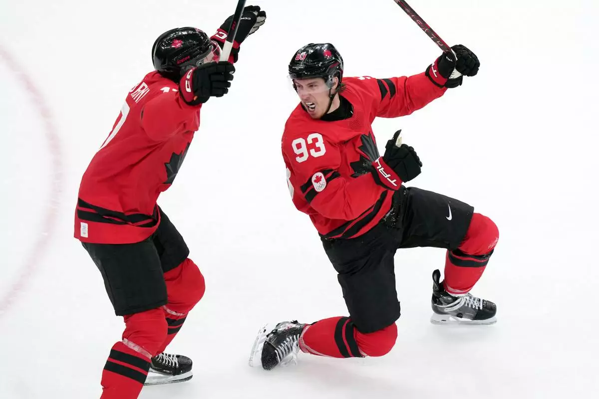 Canada's Mitch Marner (93) and Macklin Celebrini (17) celebrate after Marner scored the winning goal during the overtime period of a men's ice hockey quarterfinal game between Canada and Czechia at the 2026 Winter Olympics, in Milan, Italy, Wednesday, Feb. 18, 2026. (AP Photo/Carolyn Kaster)