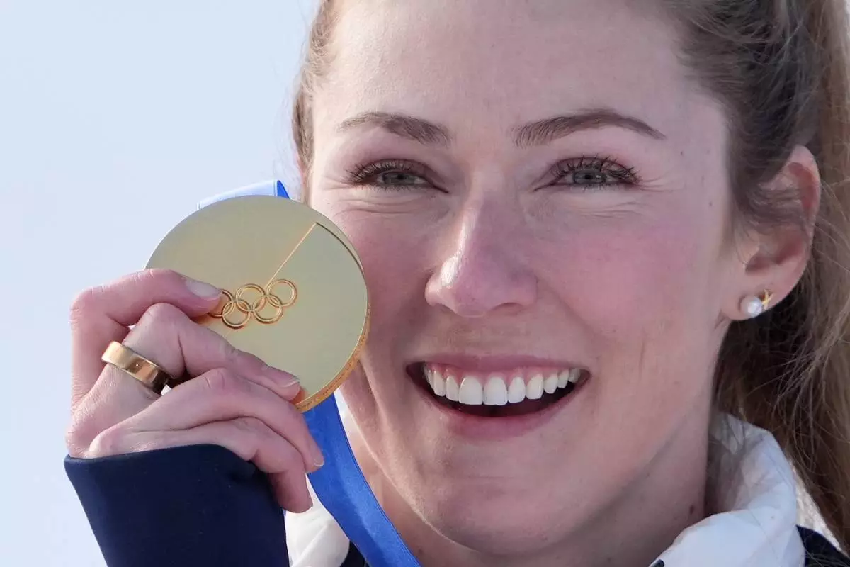 United States' Mikaela Shiffrin celebrates winning the gold medal in an alpine ski, women's slalom race, at the 2026 Winter Olympics, in Cortina d'Ampezzo, Italy, Wednesday, Feb. 18, 2026. (AP Photo/Jacquelyn Martin)