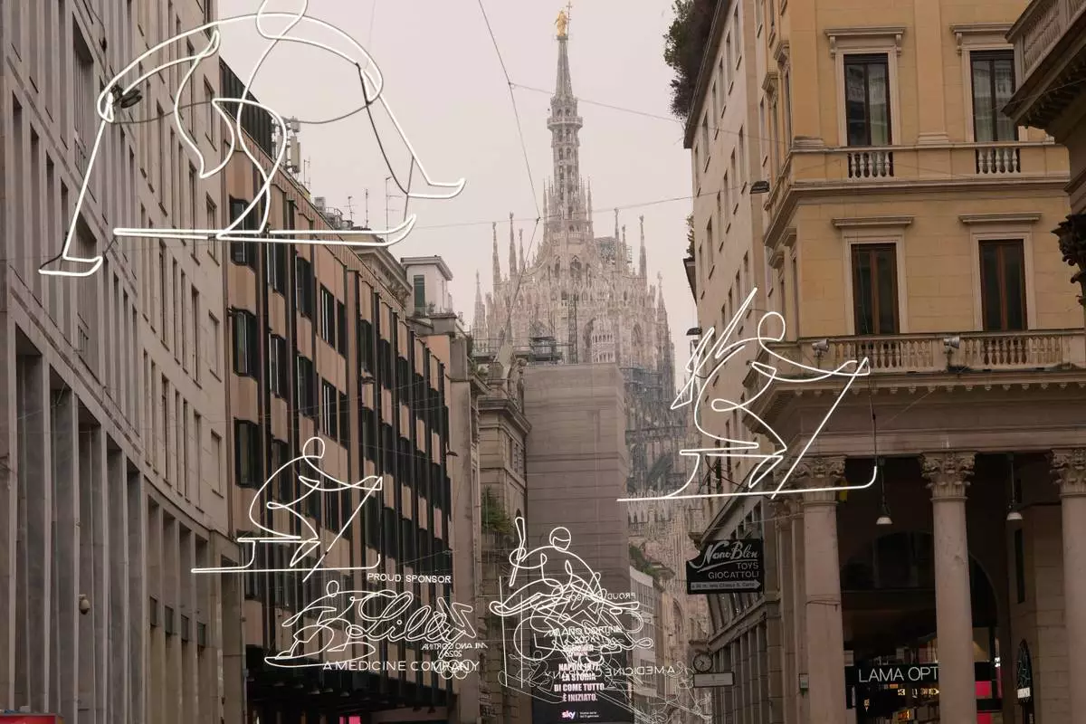 FILE - Olympic Iconic neon rings hang next to the Duomo gothic cathedral for the upcoming Milan Cortina Winter Olympics in Milan, Italy, Friday, Jan. 9, 2026. (AP Photo/Luca Bruno, File)