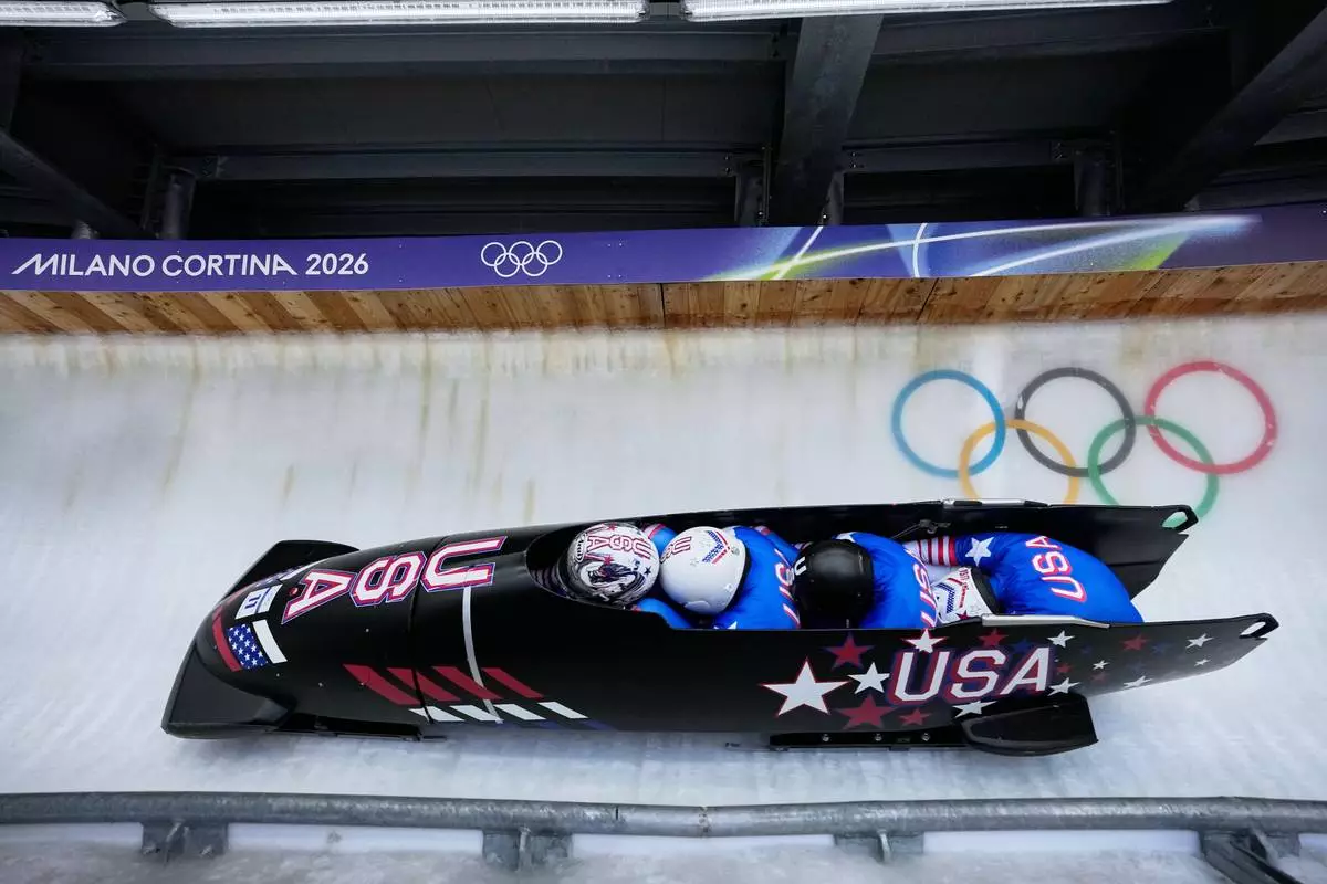 United States' Kristopher Horn, left, Caleb Furnell, Hunter Powell and Carsten Vissering slide down the track during a four man bobsled run at the 2026 Winter Olympics, in Cortina d'Ampezzo, Italy, Saturday, Feb. 21, 2026. (AP Photo/Aijaz Rahi)