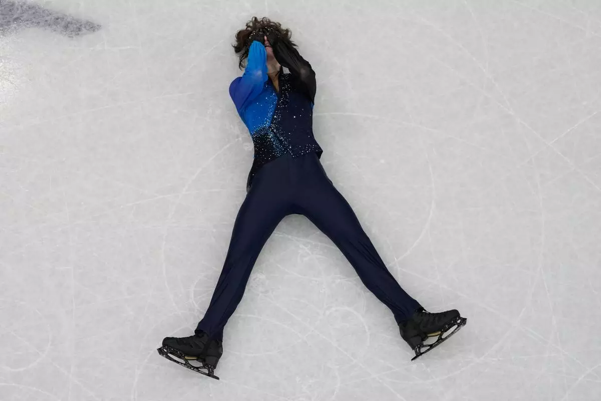 Mikhail Shaidorov of Kazakhstan reacts as he competes during the men's free skate program in figure skating at the 2026 Winter Olympics, in Milan, Italy, Friday, Feb. 13, 2026. (AP Photo/Christophe Ena)