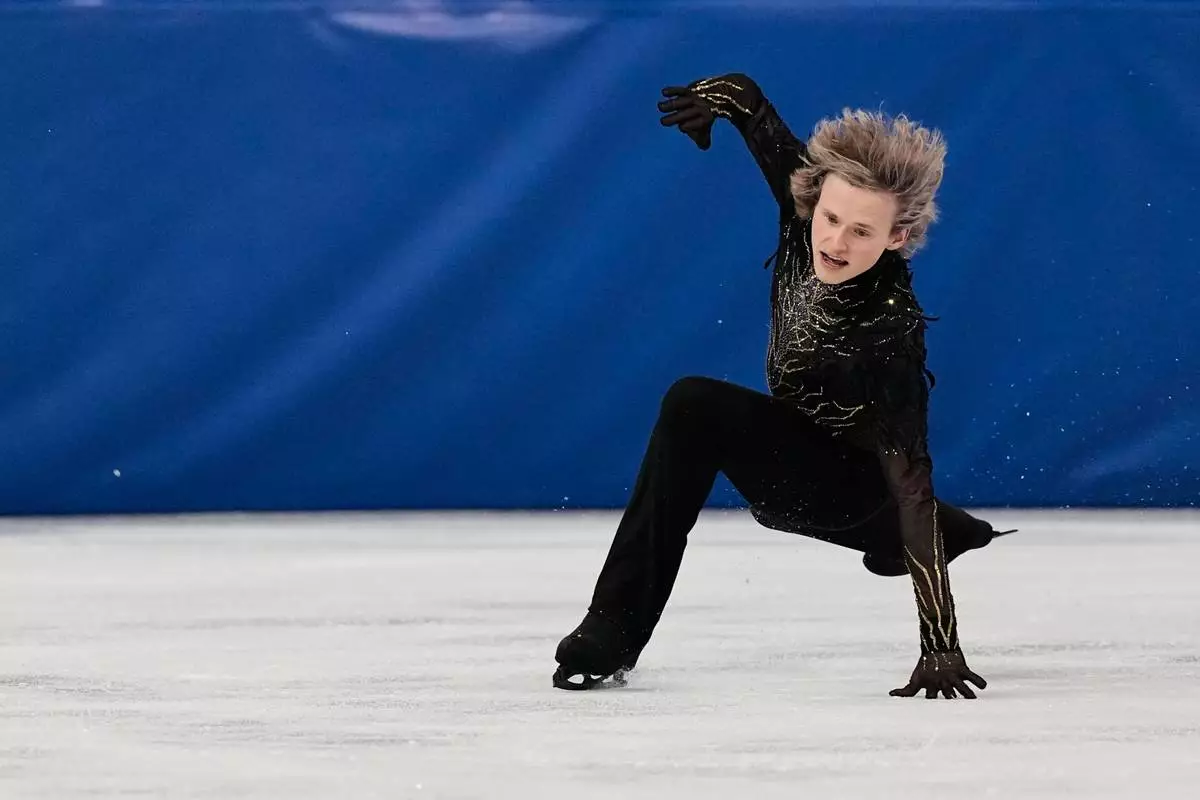 Ilia Malinin of the United States falls during the men's free skate program in figure skating at the 2026 Winter Olympics, in Milan, Italy, Friday, Feb. 13, 2026. (AP Photo/Ashley Landis)