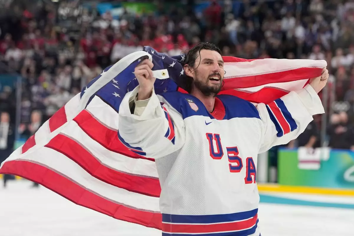 United States' Connor Hellebuyck (37) celebrate after defeating Canada during a men's ice hockey gold medal game between Canada and the United States at the 2026 Winter Olympics, in Milan, Italy, Sunday, Feb. 22, 2026. (AP Photo/Hassan Ammar)