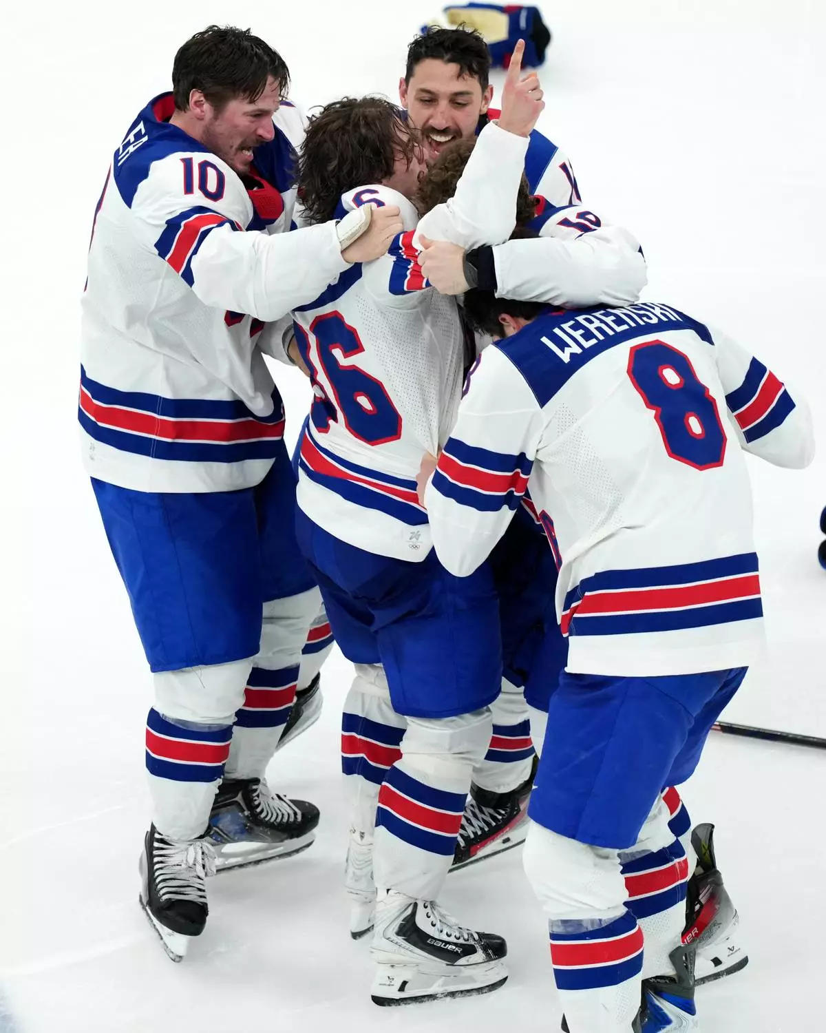 United States' JT Miller (10) and Zach Werenski (8) celebrate with Jack Hughes (86) after Hughes scored the winning goal in overtime against Canada to win the men's ice hockey gold medal game at the 2026 Winter Olympics in Milan, Italy, Sunday, Feb. 22, 2026. (AP Photo/Carolyn Kaster)