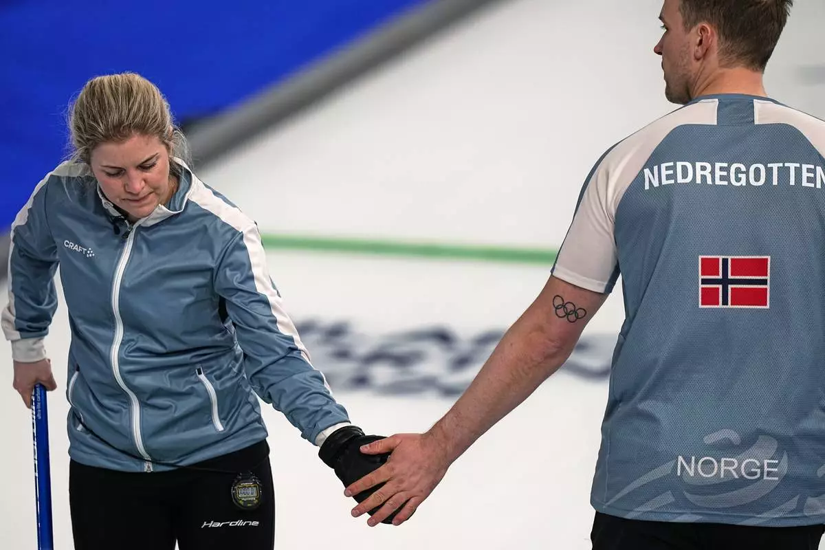 Norway's Magnus Nedregotten and Kristin Skaslien gesture, during the mixed doubles round robin phase of the curling competition against Czechia, at the 2026 Winter Olympics, in Cortina d'Ampezzo, Italy, Sunday, Feb. 8, 2026. (AP Photo/Fatima Shbair)