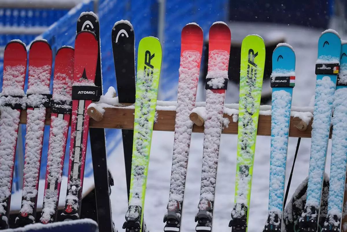 Snow-covered skis are lined up at the finish area of an alpine ski, men's slalom race, at the 2026 Winter Olympics, in Bormio, Italy, Monday, Feb. 16, 2026. (AP Photo/Rebecca Blackwell)