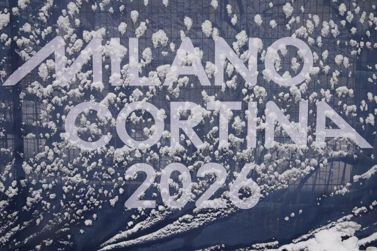 Olympic signage is covered in snow at the finish area of an alpine ski, men's slalom race, at the 2026 Winter Olympics, in Bormio, Italy, Monday, Feb. 16, 2026. (AP Photo/Rebecca Blackwell)