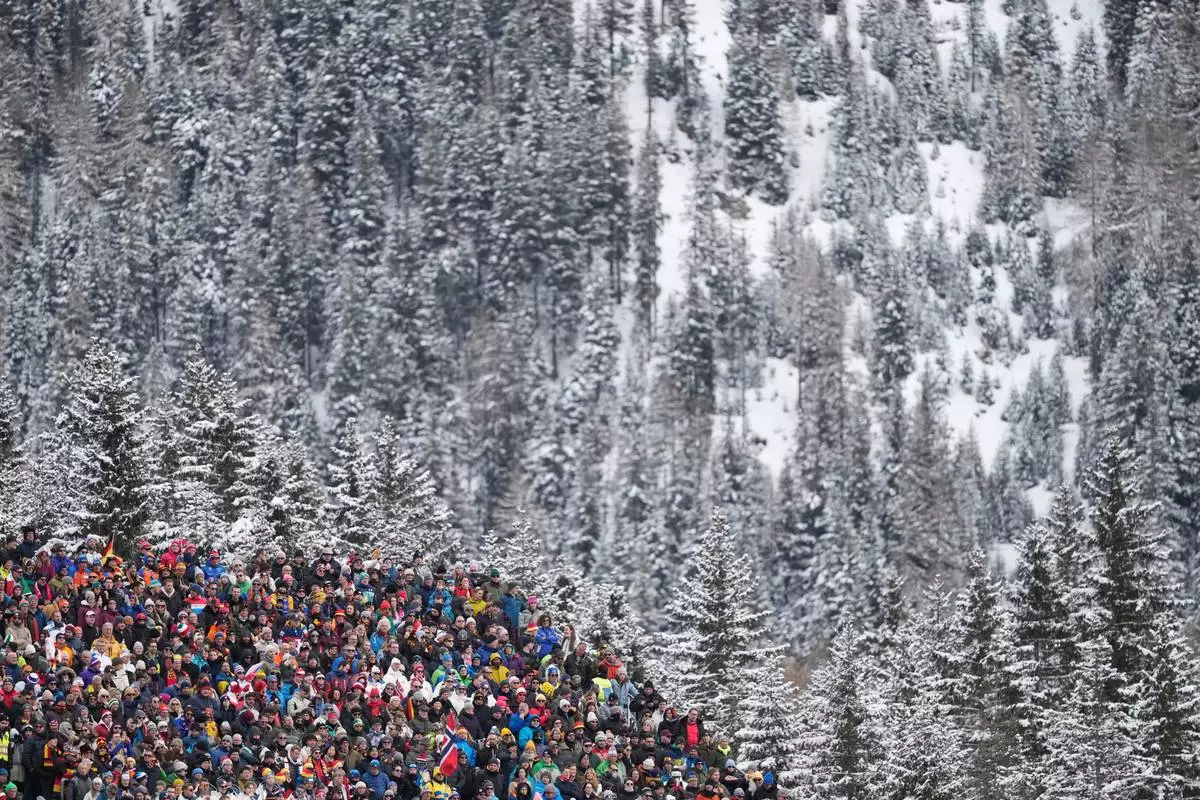 Spectators wait for the start of the women's 4x6-kilometer relay biathlon race at the 2026 Winter Olympics in Anterselva, Italy, Wednesday, Feb. 18, 2026. (AP Photo/Mosa'ab Elshamy)