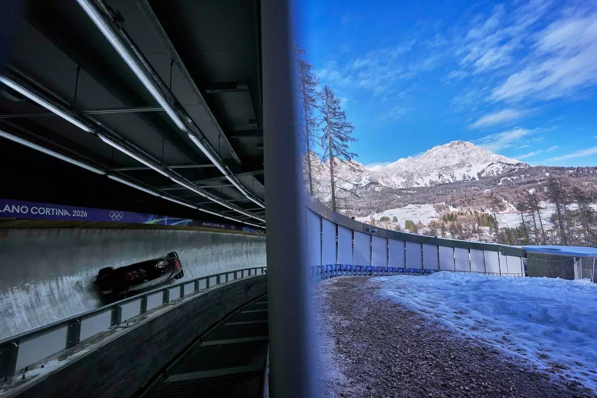 Canada's Bianca Ribi, right, slides down the track during a two women bobsled training session at the 2026 Winter Olympics, in Cortina d'Ampezzo, Italy, Wednesday, Feb. 18, 2026. (AP Photo/Alessandra Tarantino)