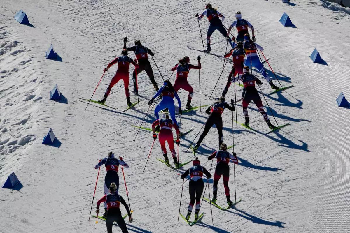 Athletes compete in the cross-country skiing women's team sprint free at the 2026 Winter Olympics, in Tesero, Italy, Wednesday, Feb. 18, 2026. (AP Photo/Matthias Schrader)