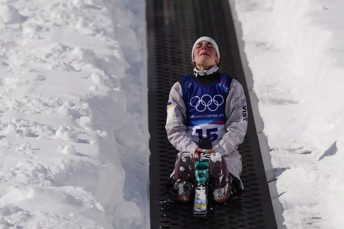 Ukraine's Anhelina Brykina (15) reacts as she rides up the magic carpet during the women's freestyle skiing aerials qualifications at the 2026 Winter Olympics, in Livigno, Italy, Wednesday, Feb. 18, 2026. (AP Photo/Julia Demaree Nikhinson)