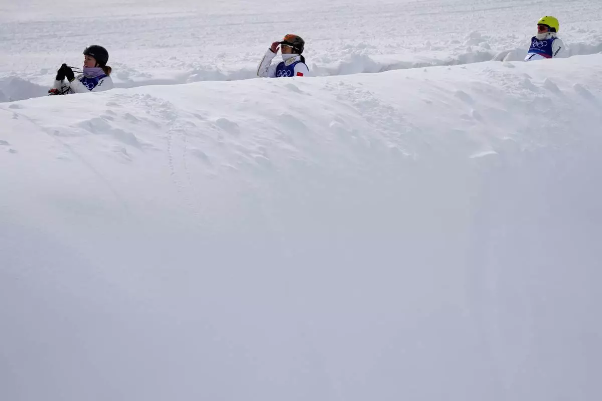Athletes ride the magic carpet before the women's freestyle skiing aerials finals at the 2026 Winter Olympics, in Livigno, Italy, Wednesday, Feb. 18, 2026. (AP Photo/Julia Demaree Nikhinson)