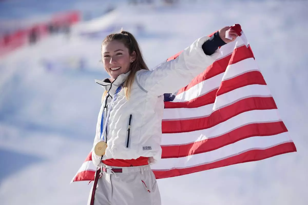 United States' Mikaela Shiffrin celebrates winning the gold medal in an alpine ski, women's slalom race, at the 2026 Winter Olympics, in Cortina d'Ampezzo, Italy, Wednesday, Feb. 18, 2026. (AP Photo/Jacquelyn Martin)