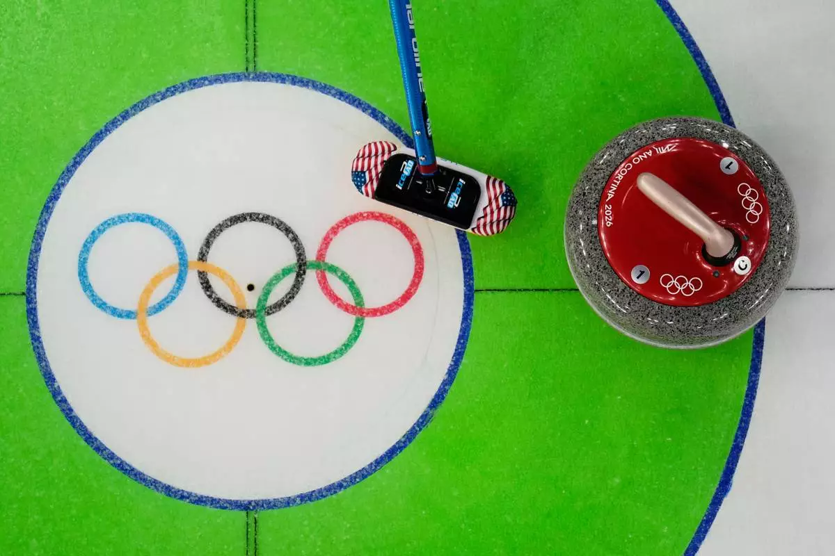 United States' Taylor Anderson-Heide sweeps near a stone during a women's curling round robin match against Denmark at the 2026 Winter Olympics, in Cortina d'Ampezzo, Italy, Tuesday, Feb. 17, 2026. (AP Photo/David J. Phillip)