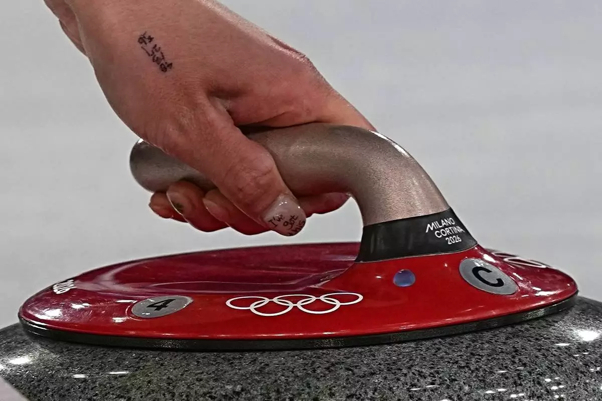 South Korea's Seol Ye-eun in action during the women's curling round robin session against Denmark, at the 2026 Winter Olympics, in Cortina d'Ampezzo, Italy, Saturday, Feb.14, 2026. (AP Photo/Fatima Shbair)