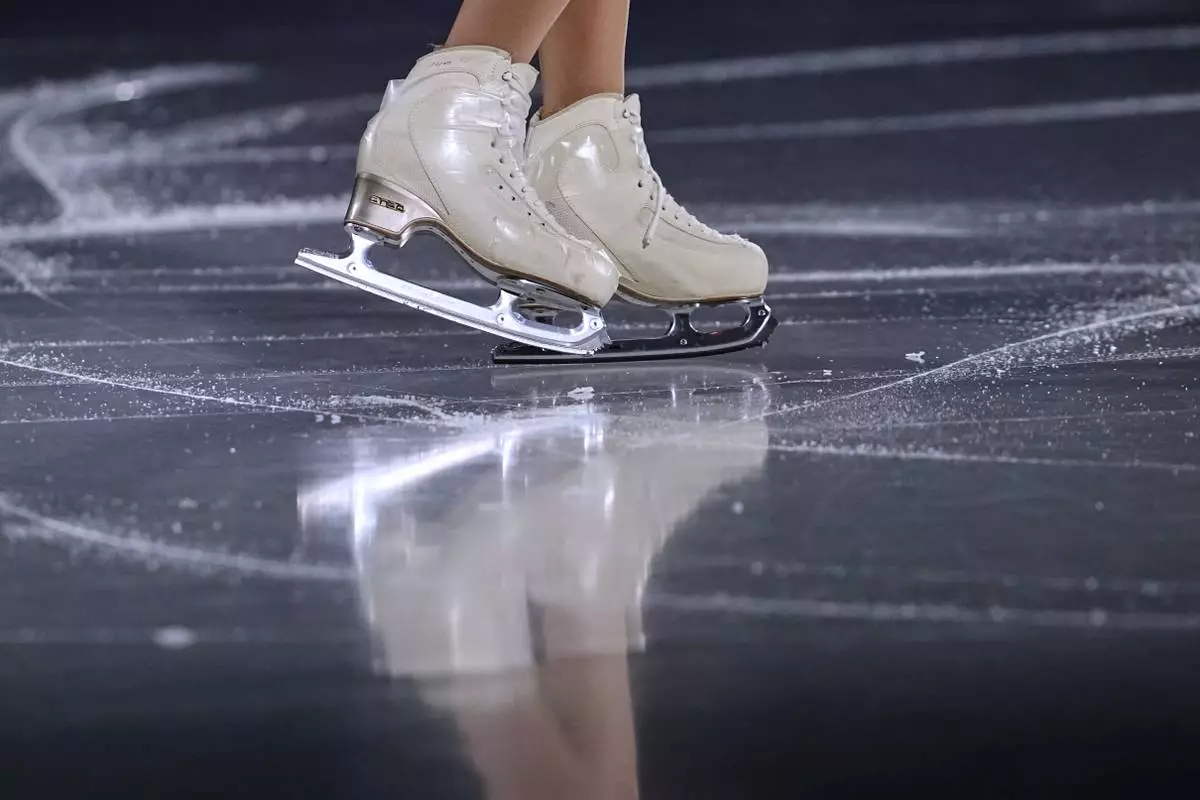 Yuna Nagaoka and Sumitada Moriguchi of Japan warm up before the pairs figure skating short program at the 2026 Winter Olympics, in Milan, Italy, Sunday, Feb. 15, 2026. (AP Photo/Ashley Landis)