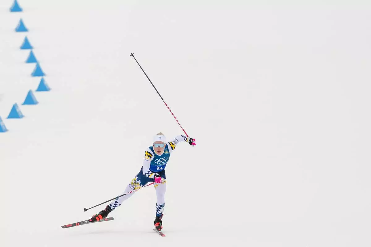Jonna Sundling, of Sweden, approaches the finish line in the cross country skiing women's 4 x 7.5km relay at the 2026 Winter Olympics, in Tesero, Italy, Saturday, Feb. 14, 2026. (AP Photo/Evgeniy Maloletka)