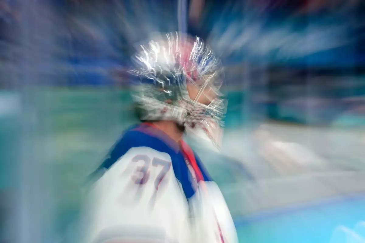 United States' Connor Hellebuyck warms up before a men's ice hockey semifinal game between the United States and Slovakia at the 2026 Winter Olympics, in Milan, Italy, Friday, Feb. 20, 2026. (AP Photo/Hassan Ammar)
