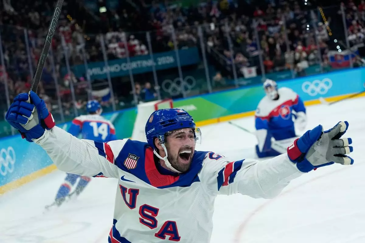 United States' Dylan Larkin (21) celebrates after scoring the opening goal during a men's ice hockey semifinal game between United States and Slovakia at the 2026 Winter Olympics, in Milan, Italy, Friday, Feb. 20, 2026. (AP Photo/Petr David Josek)
