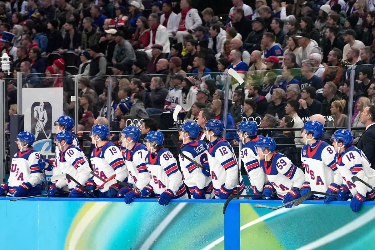 United States players look from the bench during a men's ice hockey semifinal game between the United States and Slovakia at the 2026 Winter Olympics, in Milan, Italy, Friday, Feb. 20, 2026. (AP Photo/Hassan Ammar)