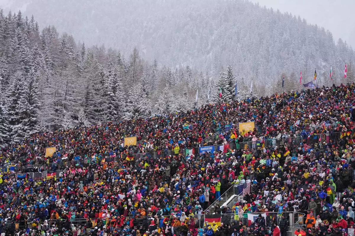 Spectators watch the men's 4x7.5-kilometer relay biathlon race at the 2026 Winter Olympics in Anterselva, Italy, Tuesday, Feb. 17, 2026. (AP Photo/Mosa'ab Elshamy)