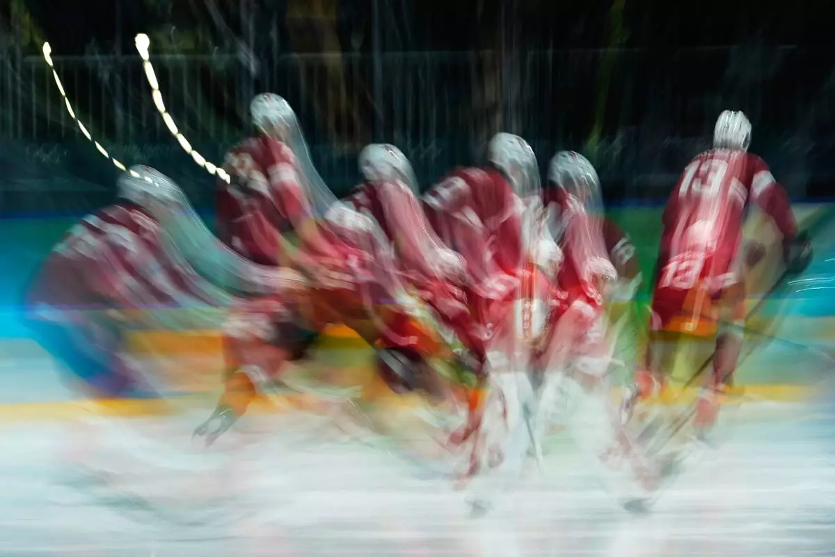 Switzerland players warm up for a men's ice hockey qualification playoff game between Switzerland and Italy at the 2026 Winter Olympics, in Milan, Italy, Tuesday, Feb. 17, 2026. (AP Photo/Petr David Josek)