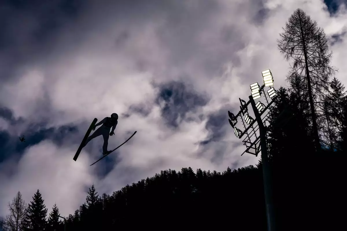 Ryota Yamamoto, of Japan, soars through the air during his competition round jump of the nordic combined individual Gundersen large hill/10km at the 2026 Winter Olympics, in Predazzo, Italy, Tuesday, Feb. 17, 2026. (AP Photo/Kirsty Wigglesworth)