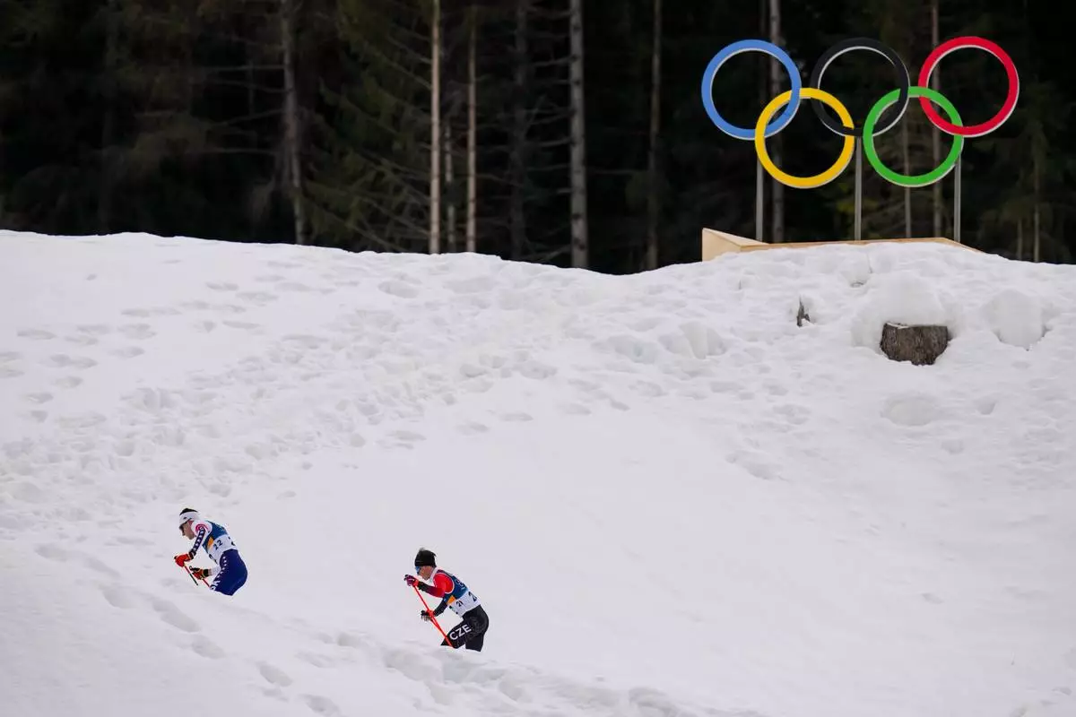 Benjamin Loomis, of the United States, left, and Jiri Konvalinka, of Czechia, compete in the nordic combined individual Gundersen large hill/10km at the 2026 Winter Olympics, in Tesero, Italy, Tuesday, Feb. 17, 2026. (AP Photo/Evgeniy Maloletka)