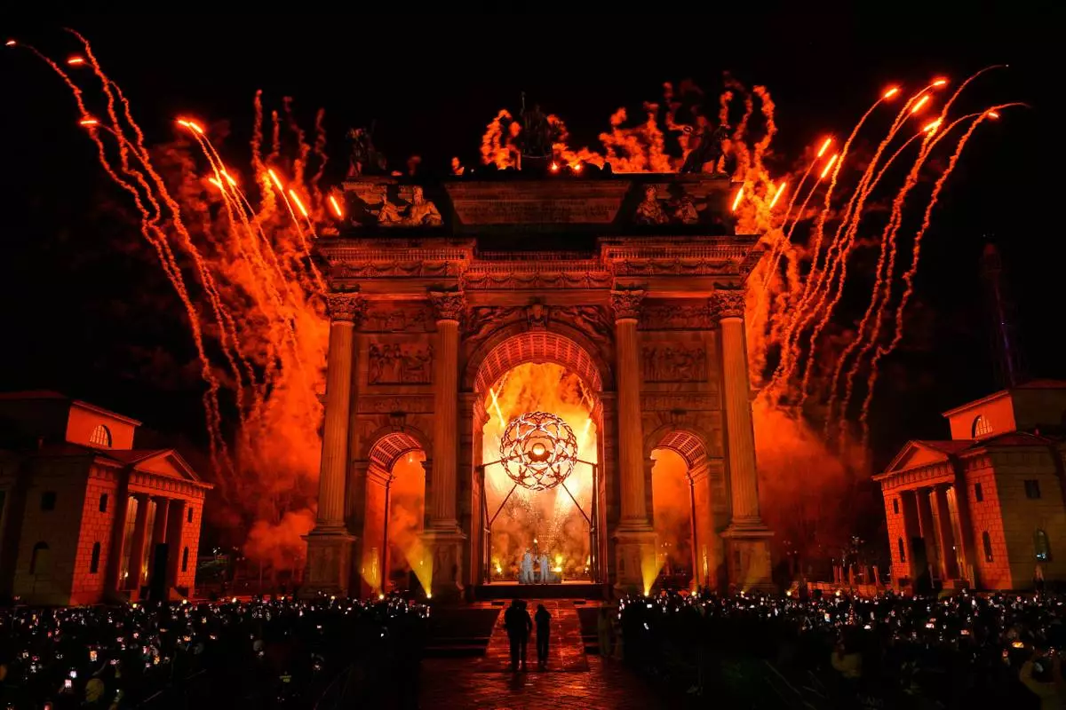 Italian former skier Deborah Compagnoni and Italian former skier Alberto Tomba light the cauldron at the Arco della Pace during the Olympic opening ceremony at the 2026 Winter Olympics, in Milan, Italy, Friday, Feb. 6, 2026. (AP Photo/Bernat Armangue)