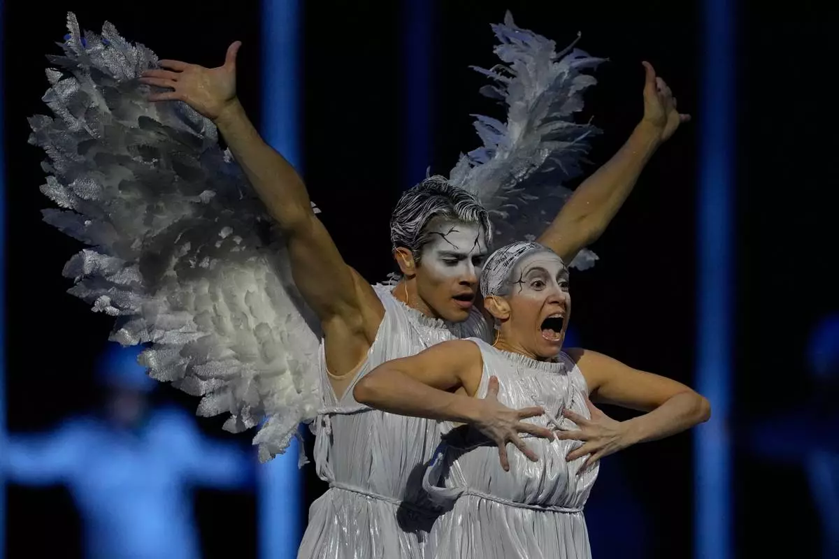 Dancers performs during the Olympic opening ceremony at the 2026 Winter Olympics, in Milan, Italy, Friday, Feb. 6, 2026 (AP Photo/Natacha Pisarenko)