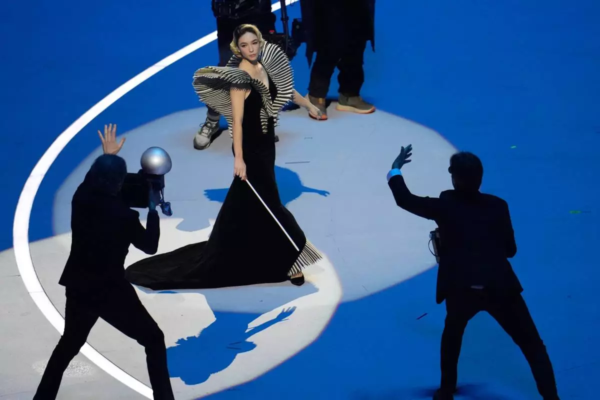 Italian actor Matilda De Angelis performs during the Olympic opening ceremony at the 2026 Winter Olympics, in Milan, Italy, Friday, Feb. 6, 2026. (AP Photo/Ben Curtis)
